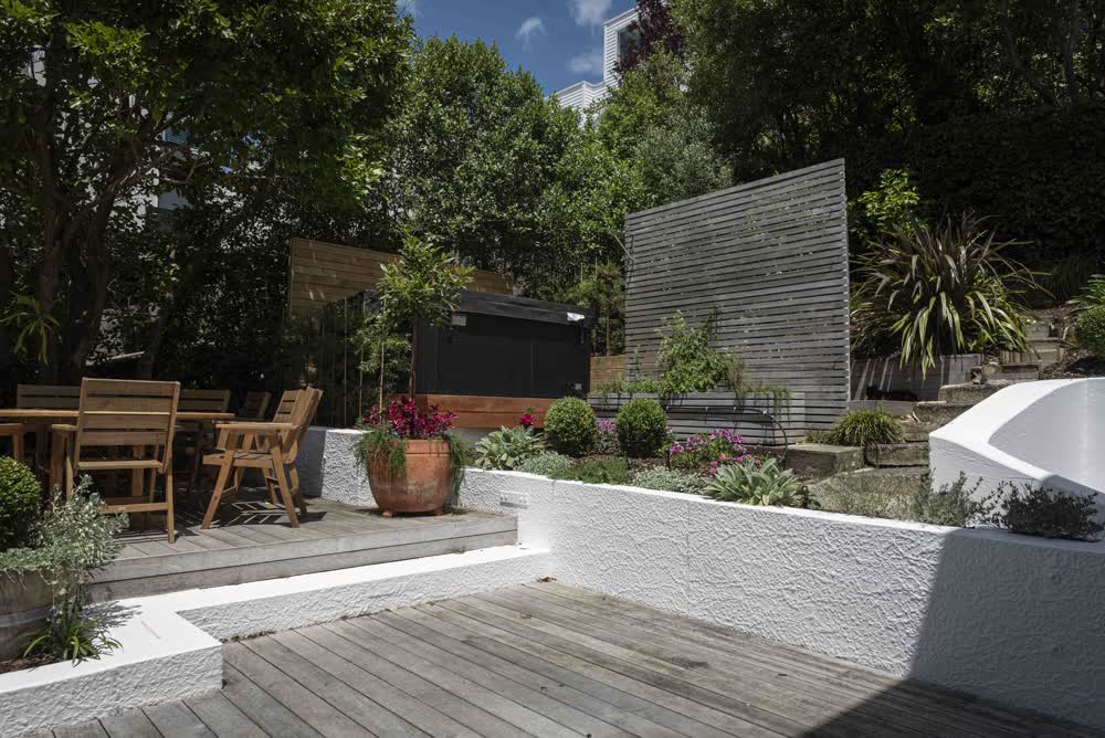 Tiered pool area with decking, spa, and seating
